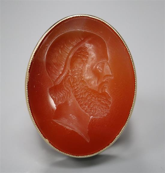 A 9ct and intaglio carnelian oval ring, carved with the head of a gentleman to dexter, size W, gross 13.1 grams.